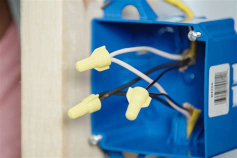 electric box with live wires behind paneling|covering electrical junction box.